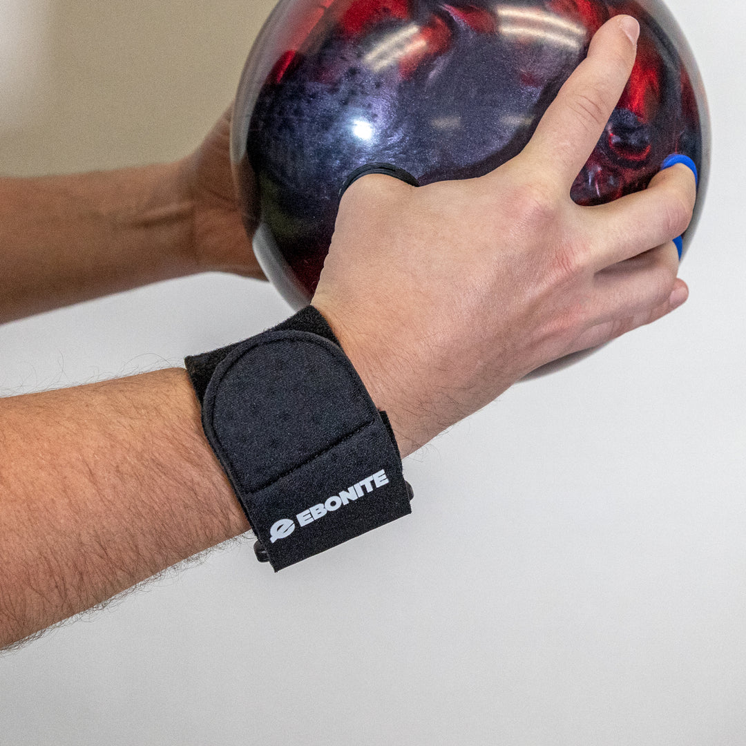 The Ultra Prene Wrist Support shown on a wrist while the bowler holds a bowling ball.